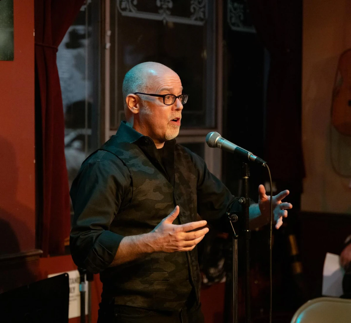 Man speaking passionately into microphone